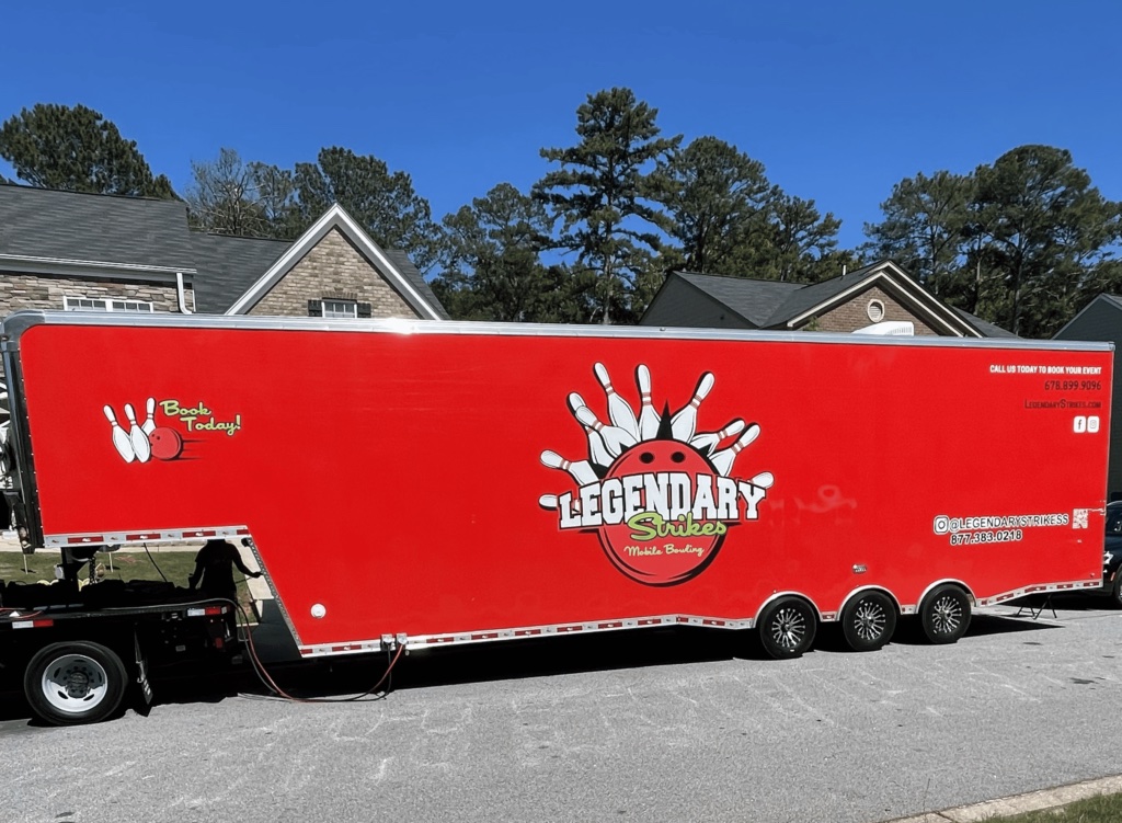 Real Legendary Strikes mobile bowling truck and game truck parked in an Atlanta neighborhood