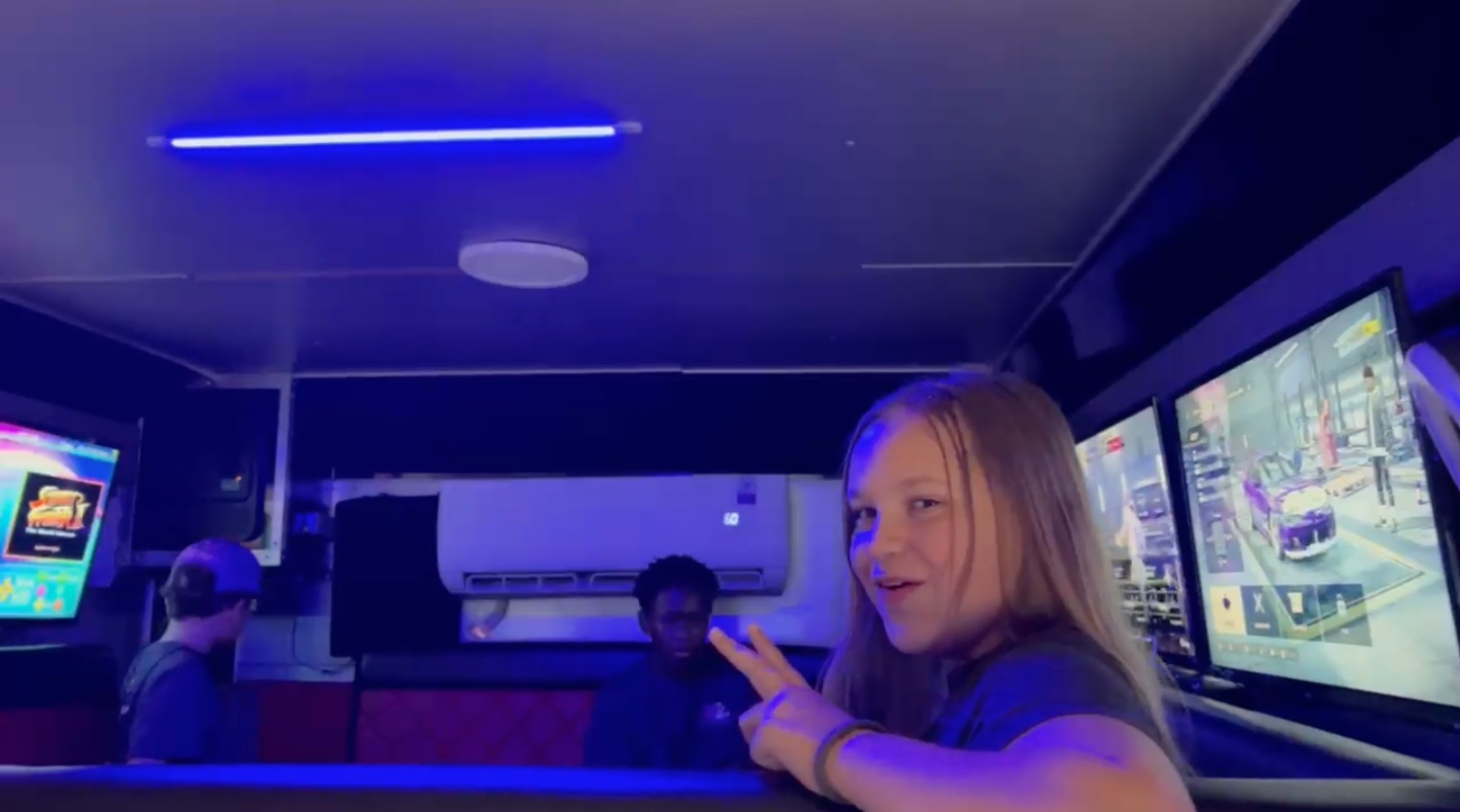 Real guest gaming and taking a selfie-style photo inside the mobile bowling truck lounge